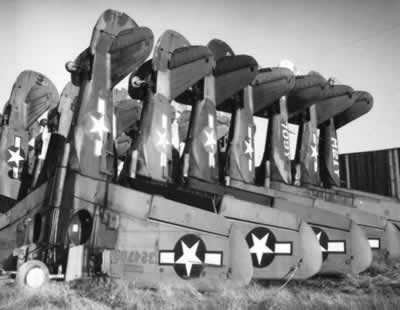 Curtiss P-40 Warhawks stacked vertically to save space before being scrapped and melted at Walnut Ridge Army Air Field, Arkansas after World War II
